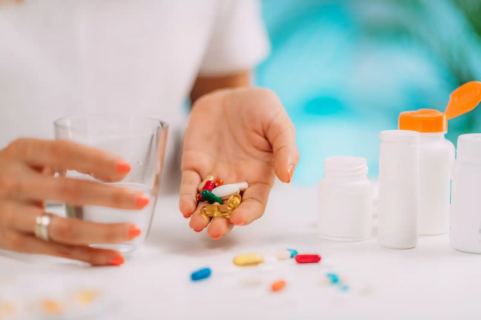 person with handful of pills compares belsomra vs ambien
