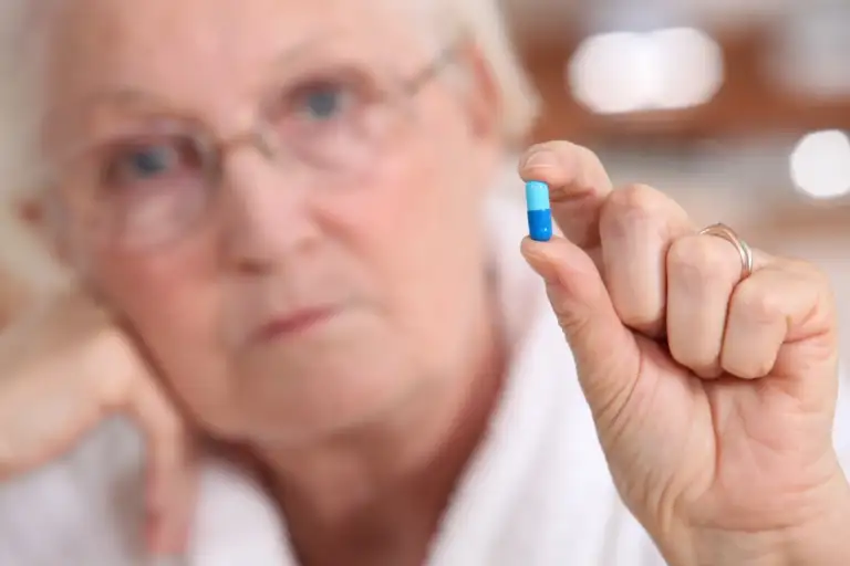 woman holding a generic antabuse tablet