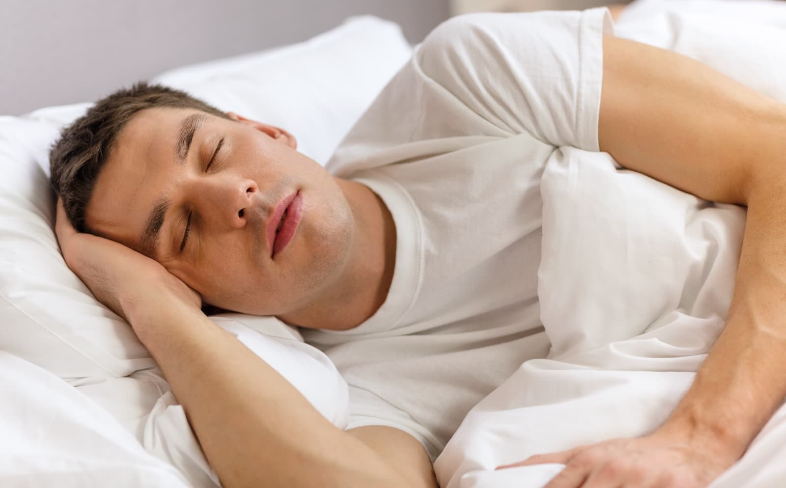 man trying to fall asleep in bed
